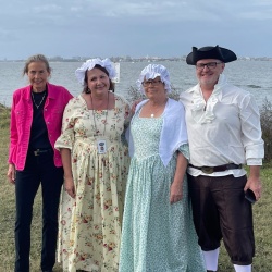 Mayor Lyon with period reenactors in front of Charleston Harbor